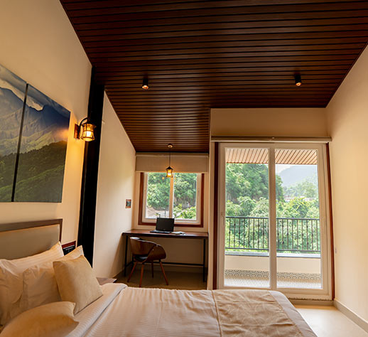 Modern hotel bedroom with wooden furnishings and ambient lighting